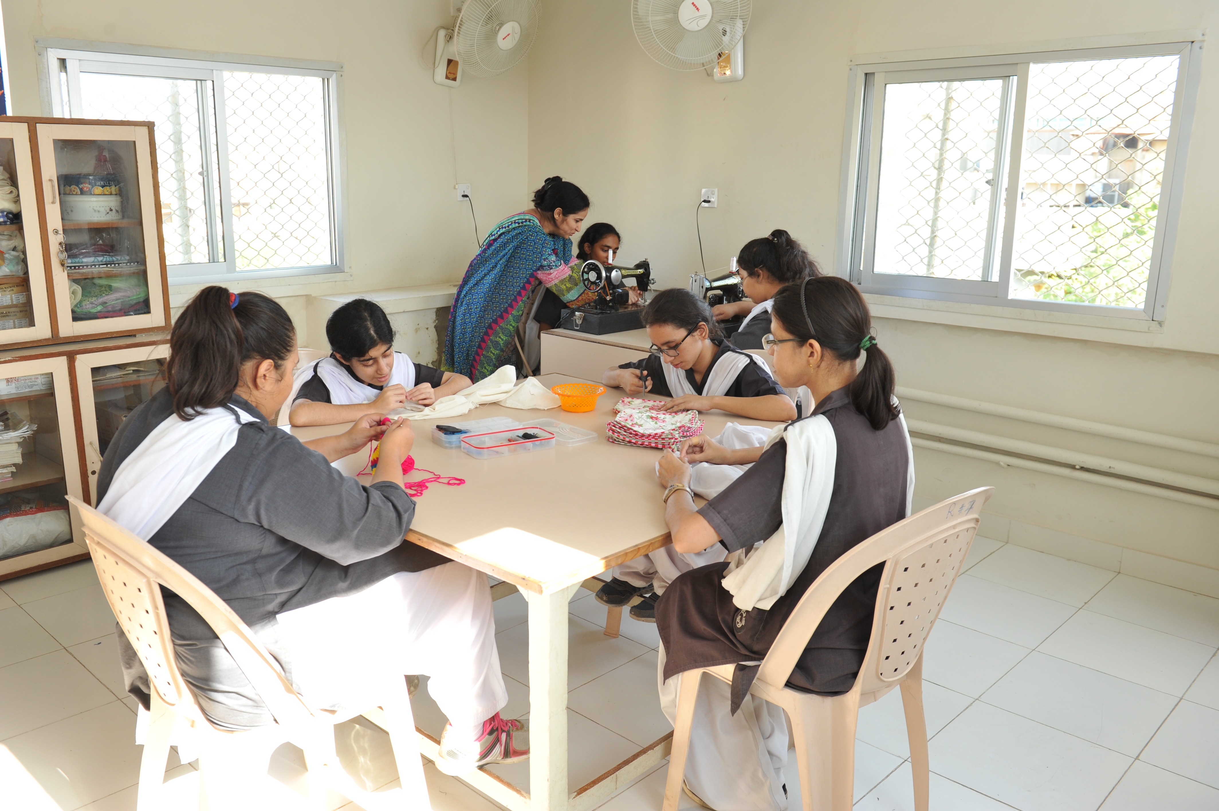 Group of students working collaboratively around a table solving building blocks puzzles